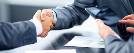 Image of men in suits shaking hands
