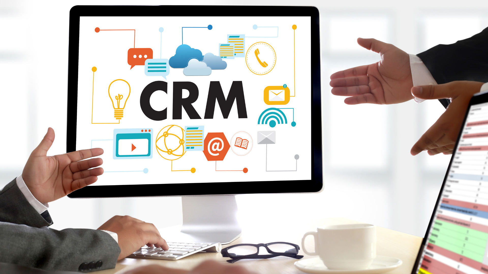 Image of business people around computer displaying the word CRM