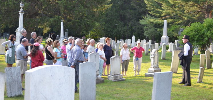 Photo of a tour taking place in a sunny cemetery