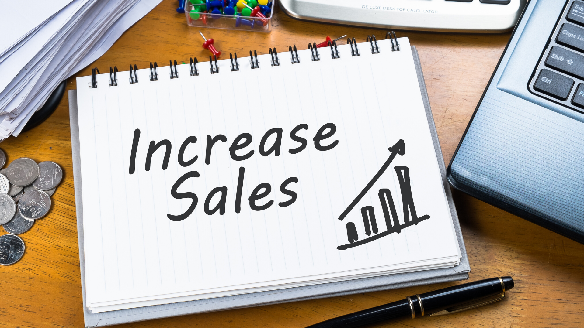 Image of the words 'increase sales' on a notebook
