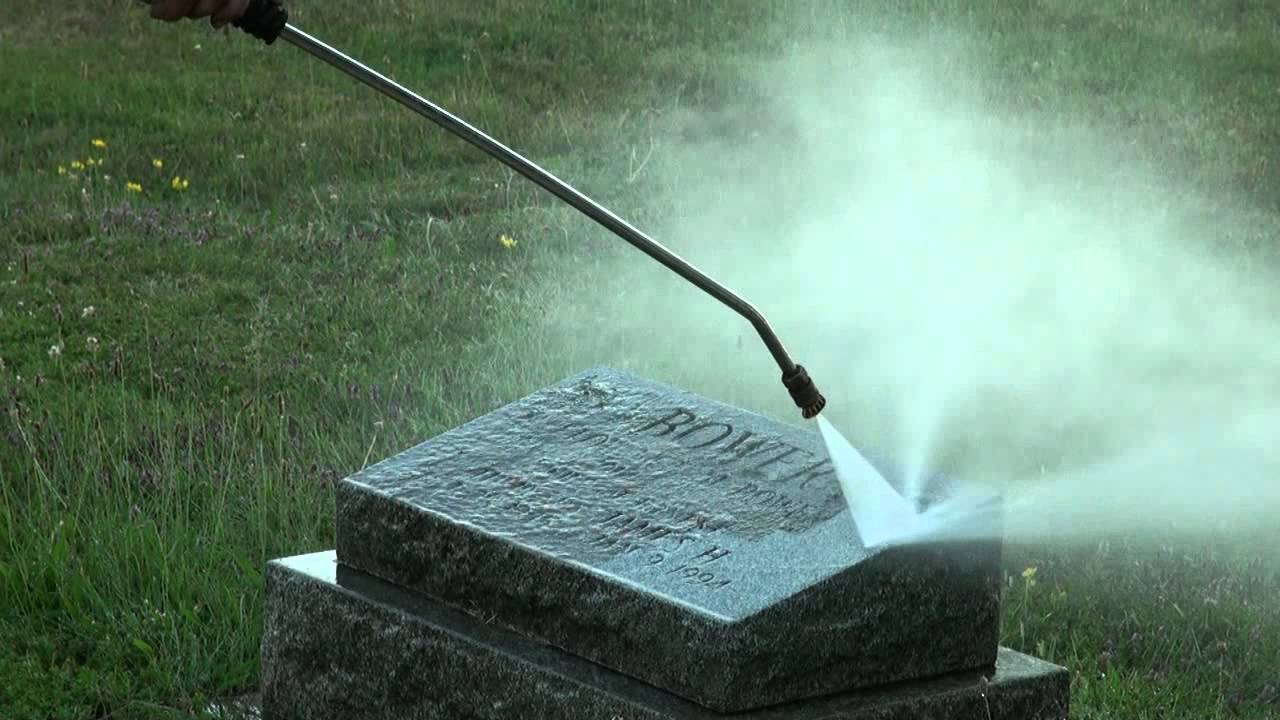 Photo of a headstone being power hosed